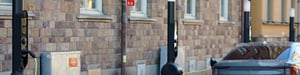 Qwello lamppost-style charging stations on a street in Sweden, with an electric vehicle charging